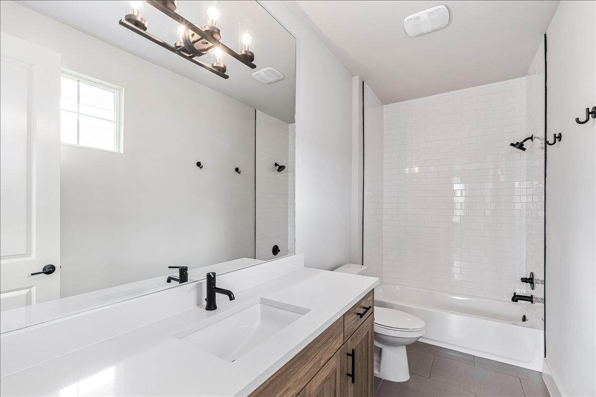 7910 Ryans Way Austin, TX 78726 - Photo 27 of 39 Modern fixtures complement this guest bathroom’s fresh design.
