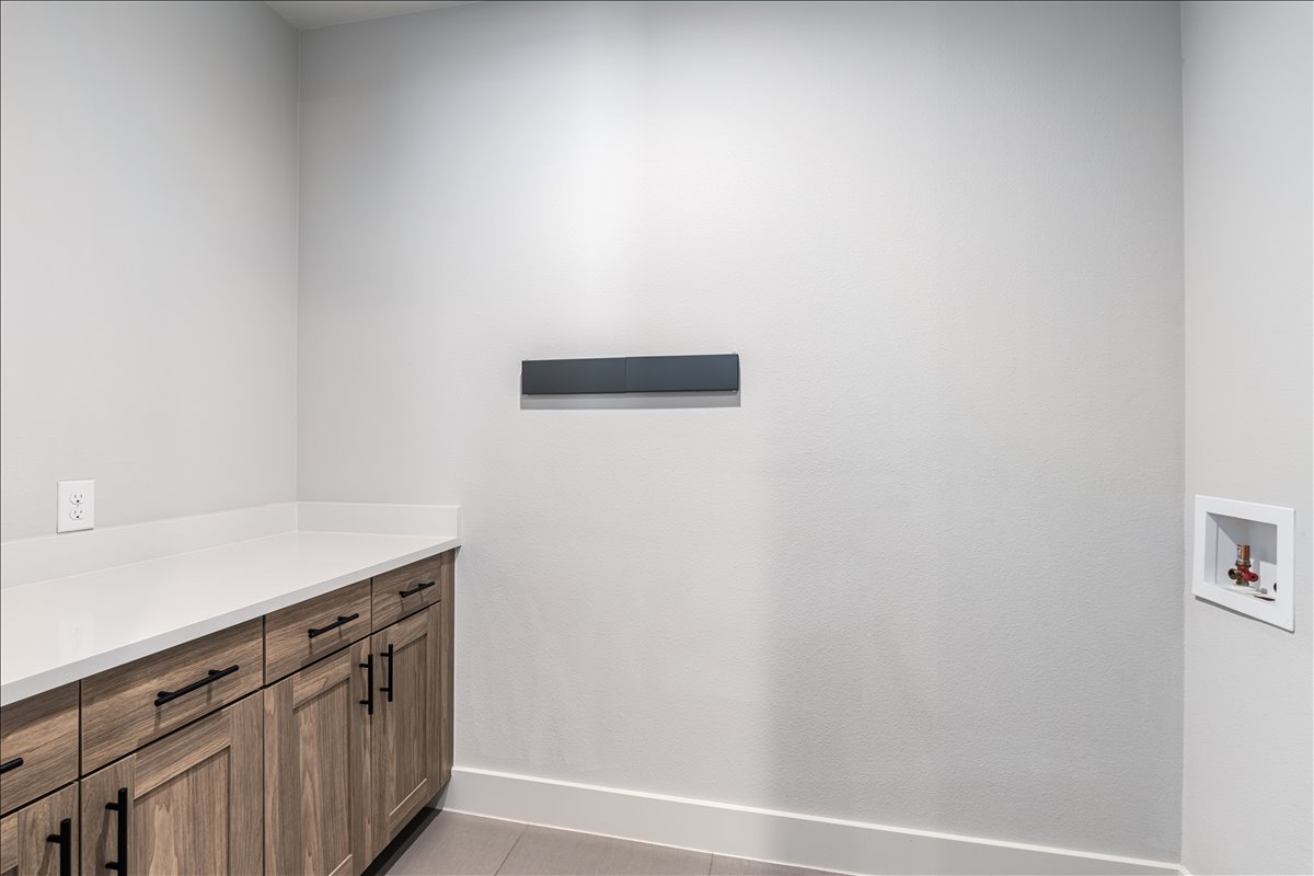 7910 Ryans Way Austin, TX 78726 - Photo 33 of 39 The spacious laundry room features built-in cabinetry that provides excellent storage for cleaning supplies and household essentials.