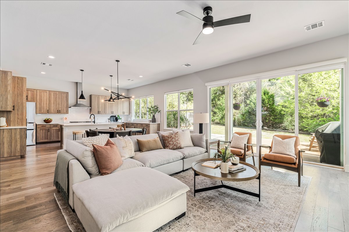 7910 Ryans Way Austin, TX 78726 - Photo 4 of 39 The spacious living room features soaring ceilings and expansive windows that fill the space with natural light.