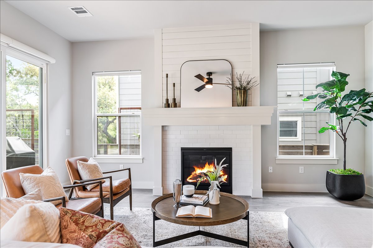 7910 Ryans Way Austin, TX 78726 - Photo 7 of 39 A modern fireplace with clean white surround creates a cozy focal point for the room.