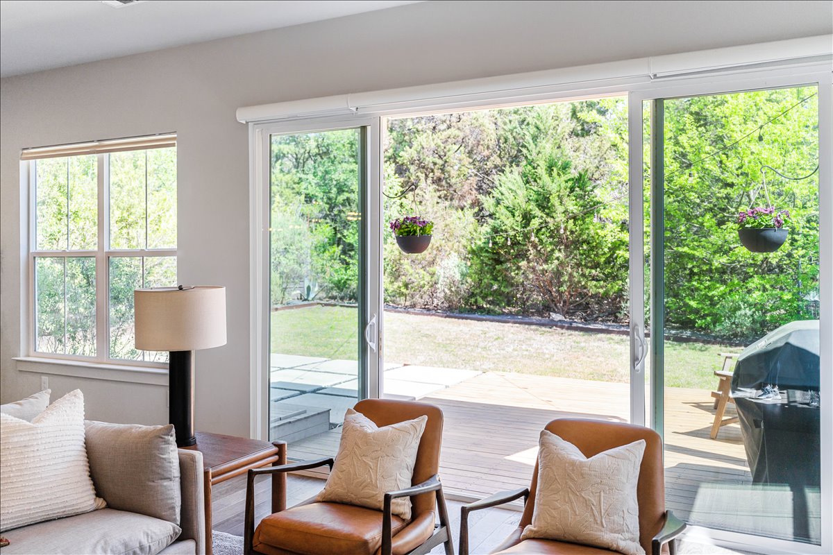 7910 Ryans Way Austin, TX 78726 - Photo 8 of 39 Large sliding glass doors provide beautiful views of the backyard and greenbelt beyond.