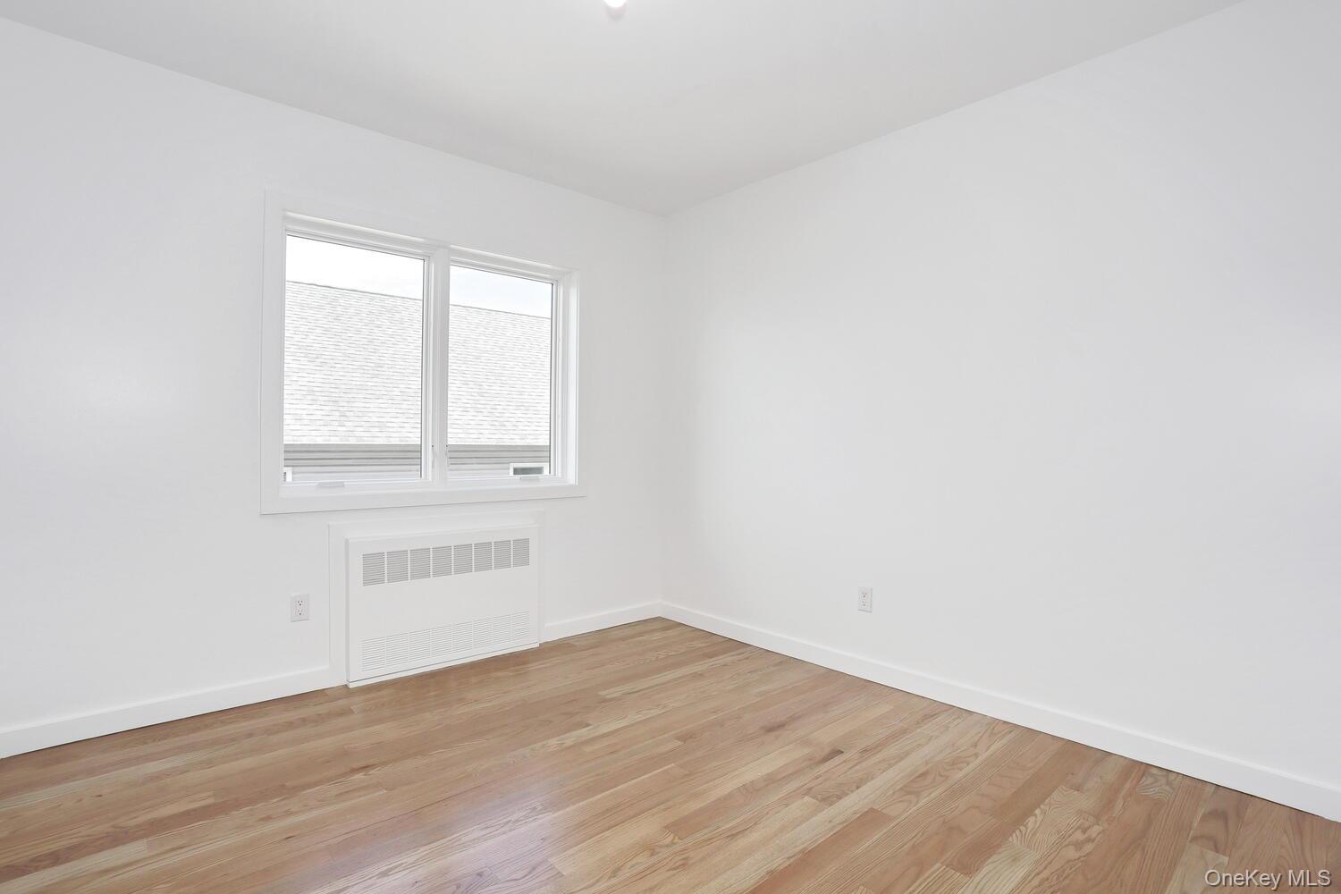 37 Ewing Avenue, Unit 202 Spring Valley, NY 10977 - Photo 26 of 50 an empty room with wooden floor and windows