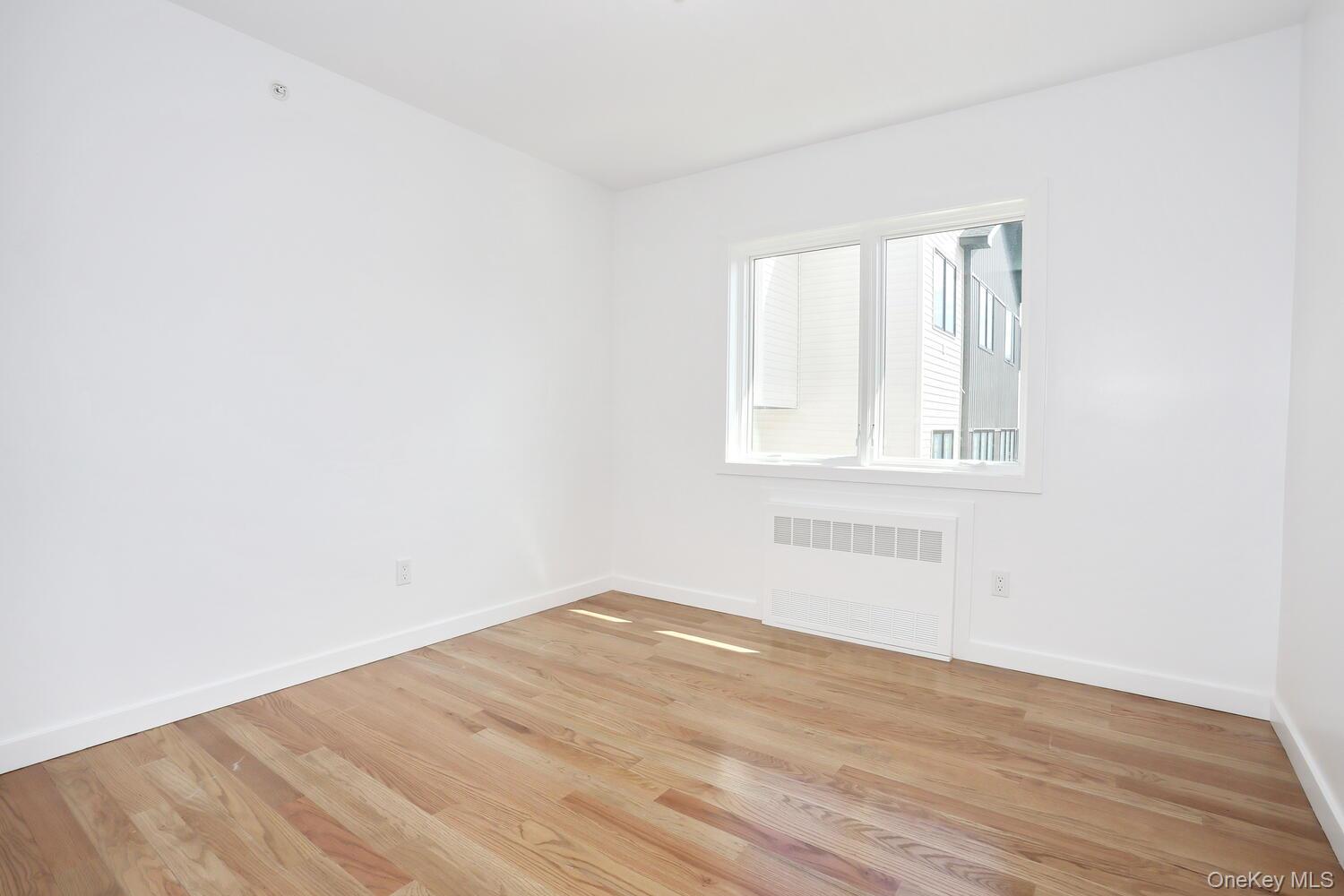 37 Ewing Avenue, Unit 202 Spring Valley, NY 10977 - Photo 27 of 50 an empty room with wooden floor and windows