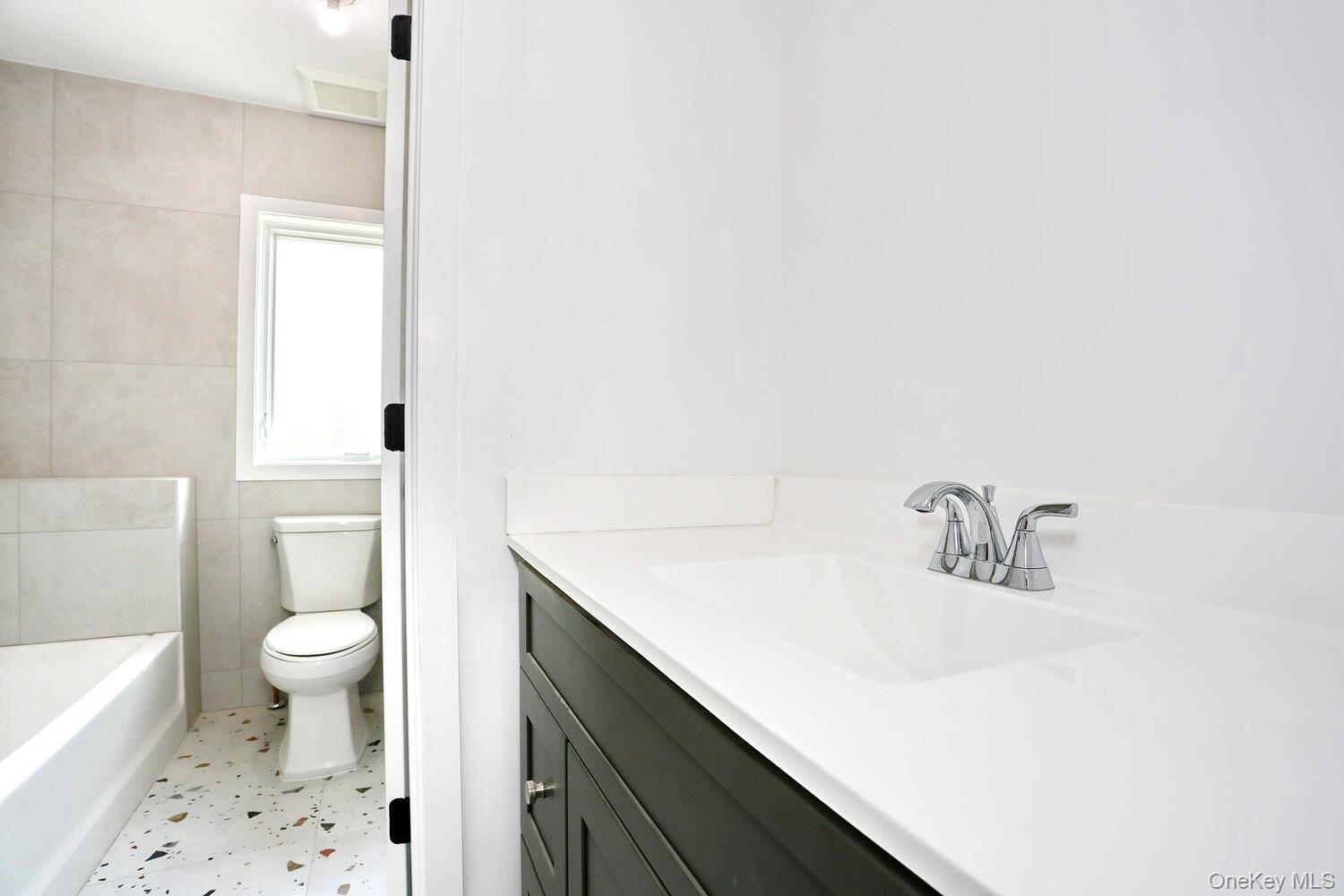 37 Ewing Avenue, Unit 202 Spring Valley, NY 10977 - Photo 28 of 50 a bathroom with a sink a toilet and shower