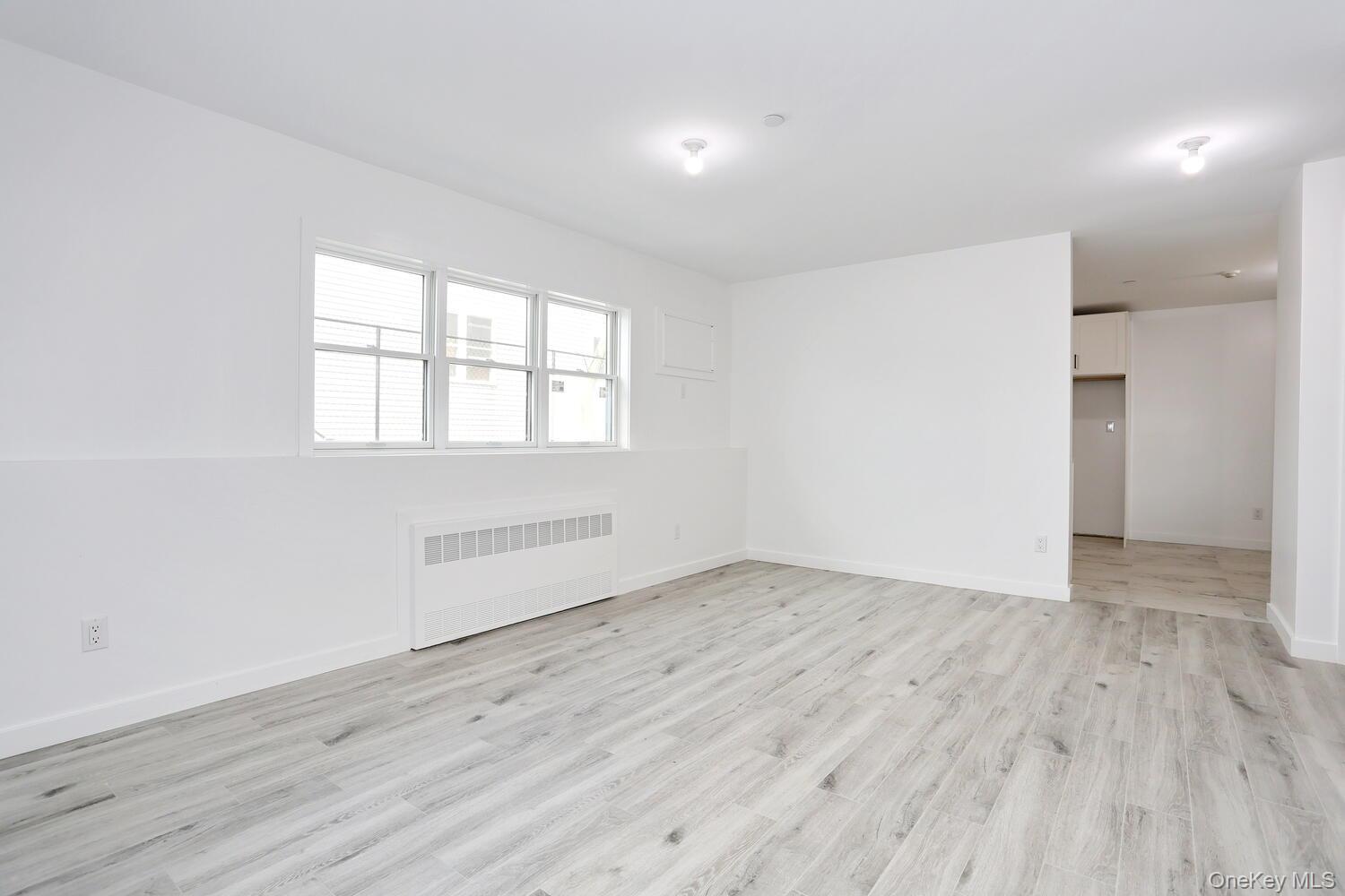 37 Ewing Avenue, Unit 202 Spring Valley, NY 10977 - Photo 34 of 50 an empty room with wooden floor and windows