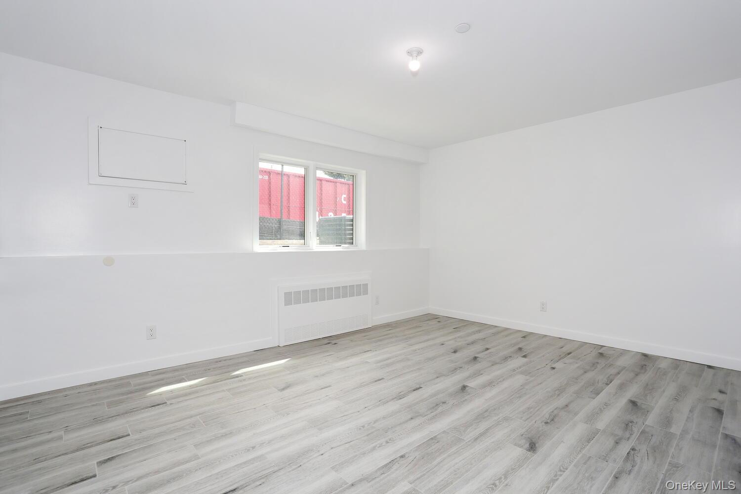 37 Ewing Avenue, Unit 202 Spring Valley, NY 10977 - Photo 37 of 50 an empty room with wooden floor and windows