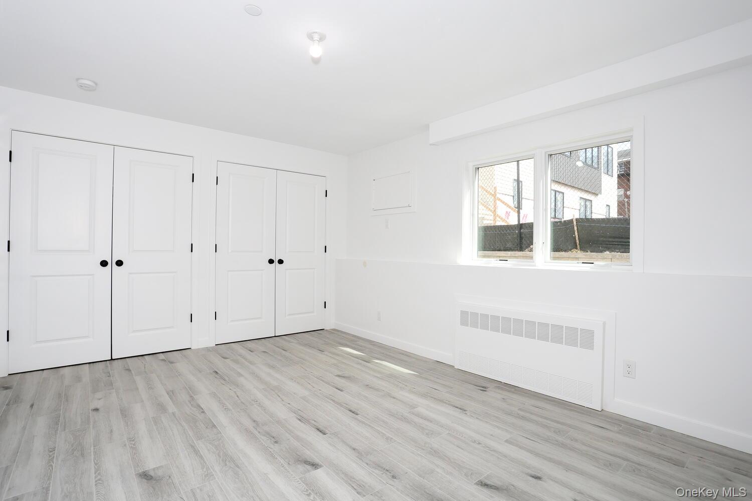 37 Ewing Avenue, Unit 202 Spring Valley, NY 10977 - Photo 38 of 50 a view of an empty room with wooden floor and a window