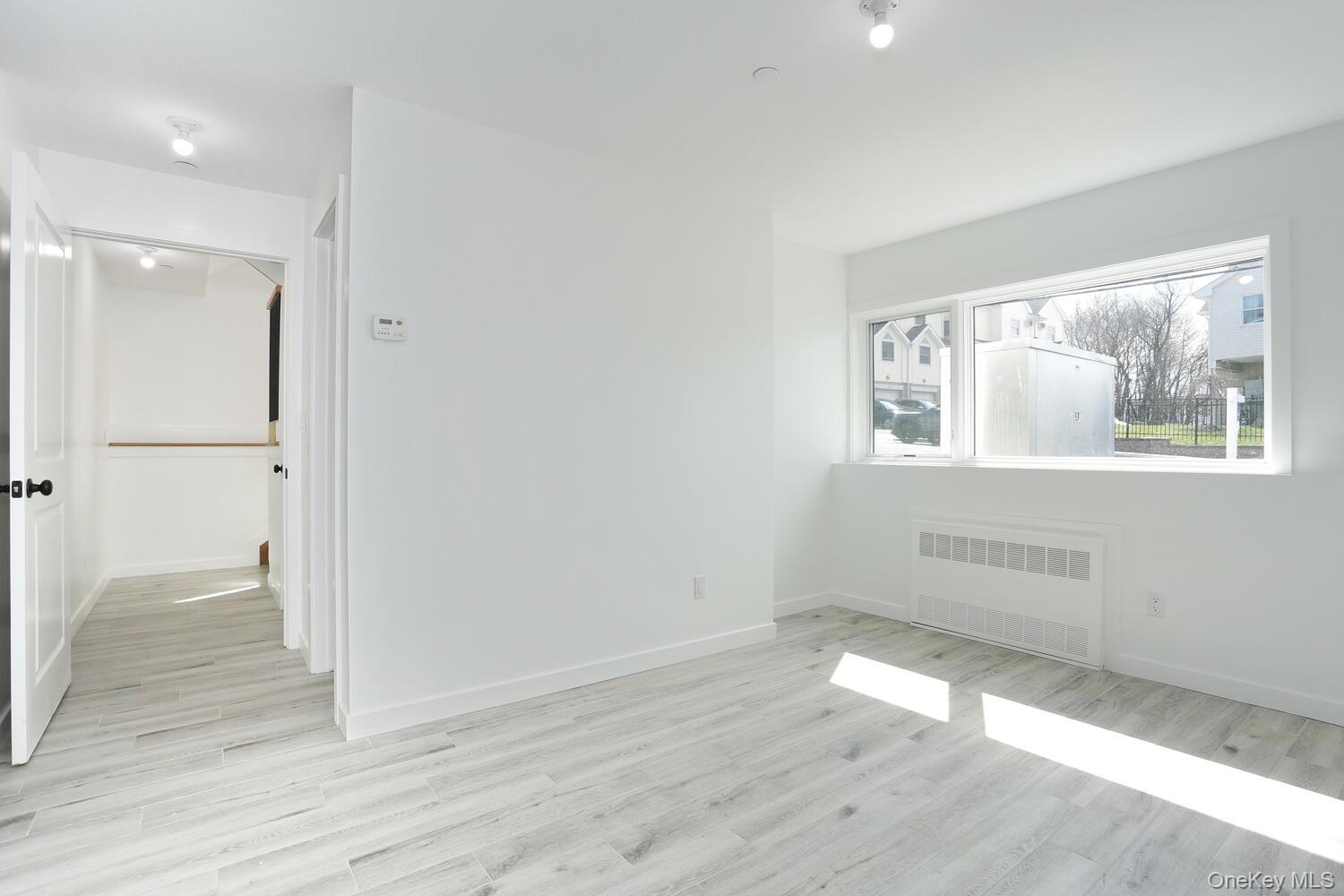 37 Ewing Avenue, Unit 202 Spring Valley, NY 10977 - Photo 41 of 50 an empty room with wooden floor and windows