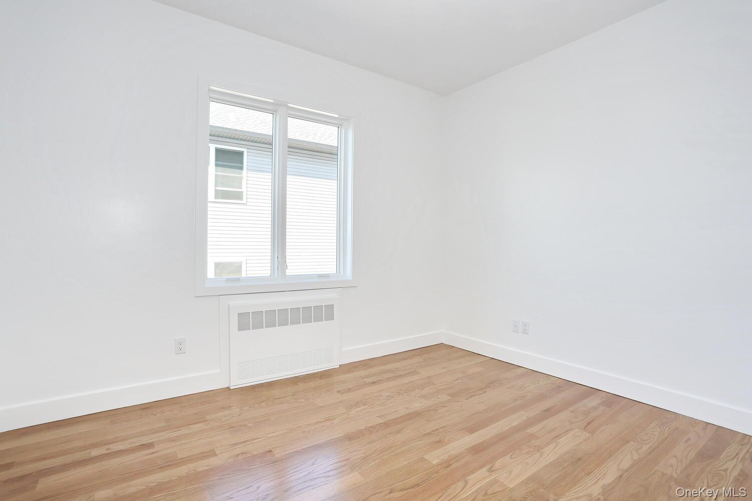 37 Ewing Avenue, Unit 202 Spring Valley, NY 10977 - Photo 9 of 50 an empty room with wooden floor and windows