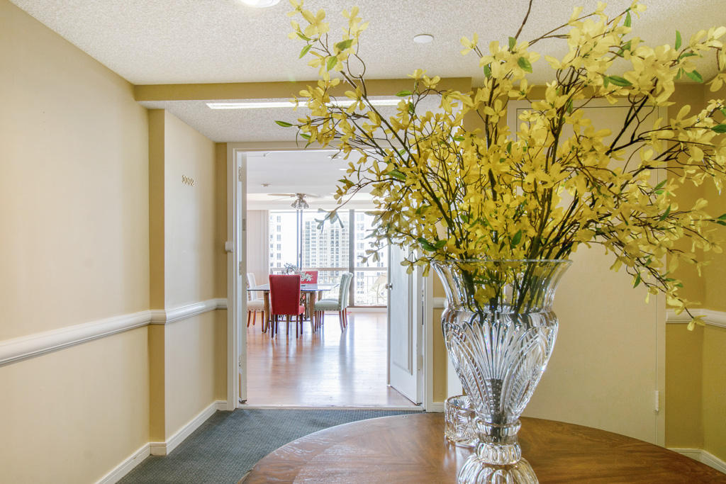4100 North Ocean Drive, Unit 1002 Singer Island, FL 33404 - Photo 11 of 37 a view of a porch with chairs and potted plants
