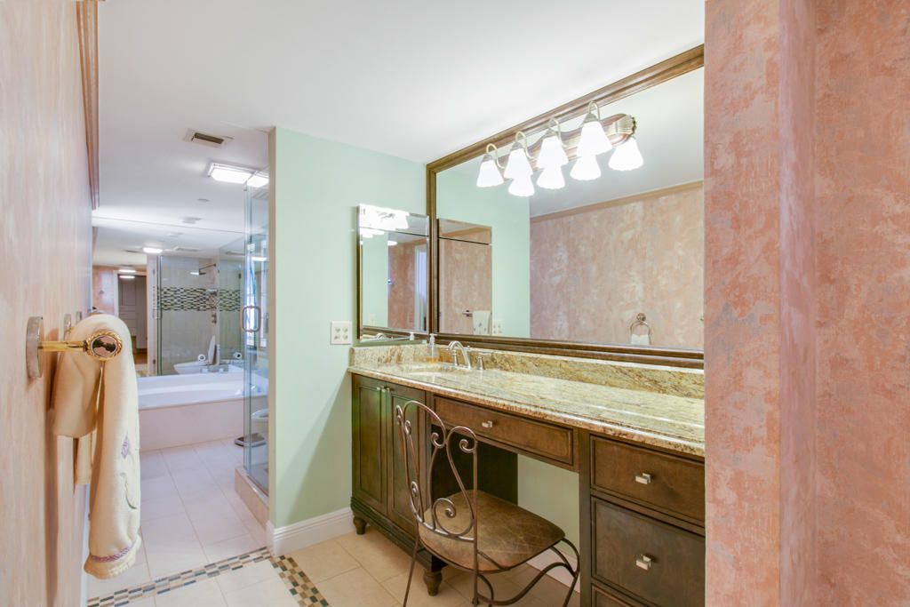 4100 North Ocean Drive, Unit 1002 Singer Island, FL 33404 - Photo 19 of 37 a view of a bathroom with a sink and mirror