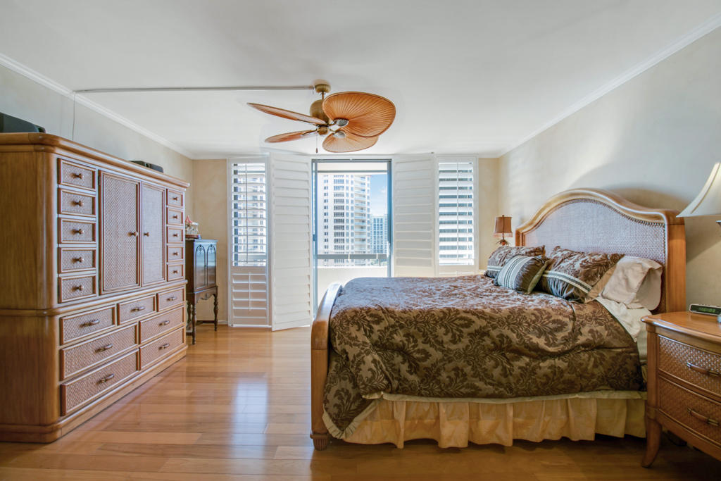 4100 North Ocean Drive, Unit 1002 Singer Island, FL 33404 - Photo 20 of 37 a bedroom with a bed and wooden floor