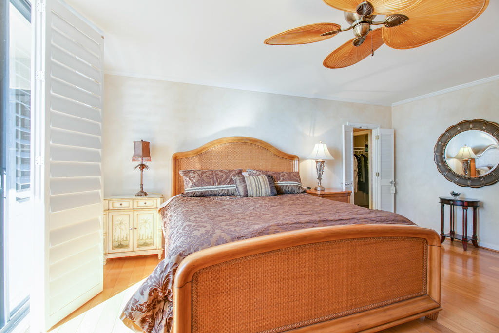 4100 North Ocean Drive, Unit 1002 Singer Island, FL 33404 - Photo 21 of 37 a bedroom with a bed and a chandelier