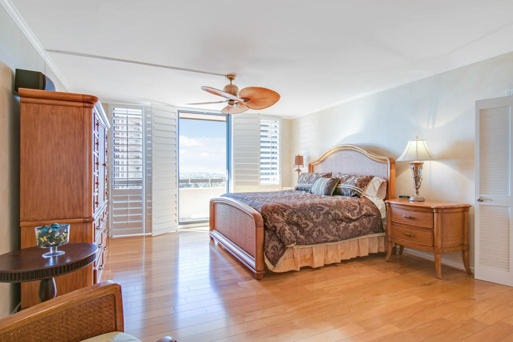 4100 North Ocean Drive, Unit 1002 Singer Island, FL 33404 - Photo 22 of 37 a bedroom with a bed and wooden floor