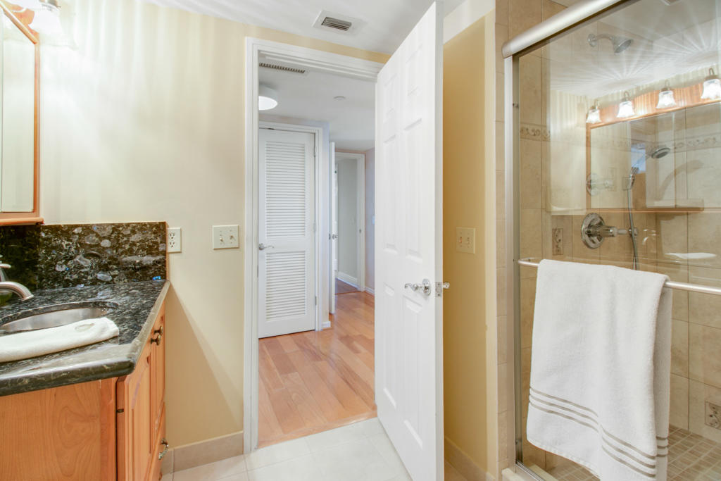 4100 North Ocean Drive, Unit 1002 Singer Island, FL 33404 - Photo 24 of 37 a bathroom with a sink and a mirror