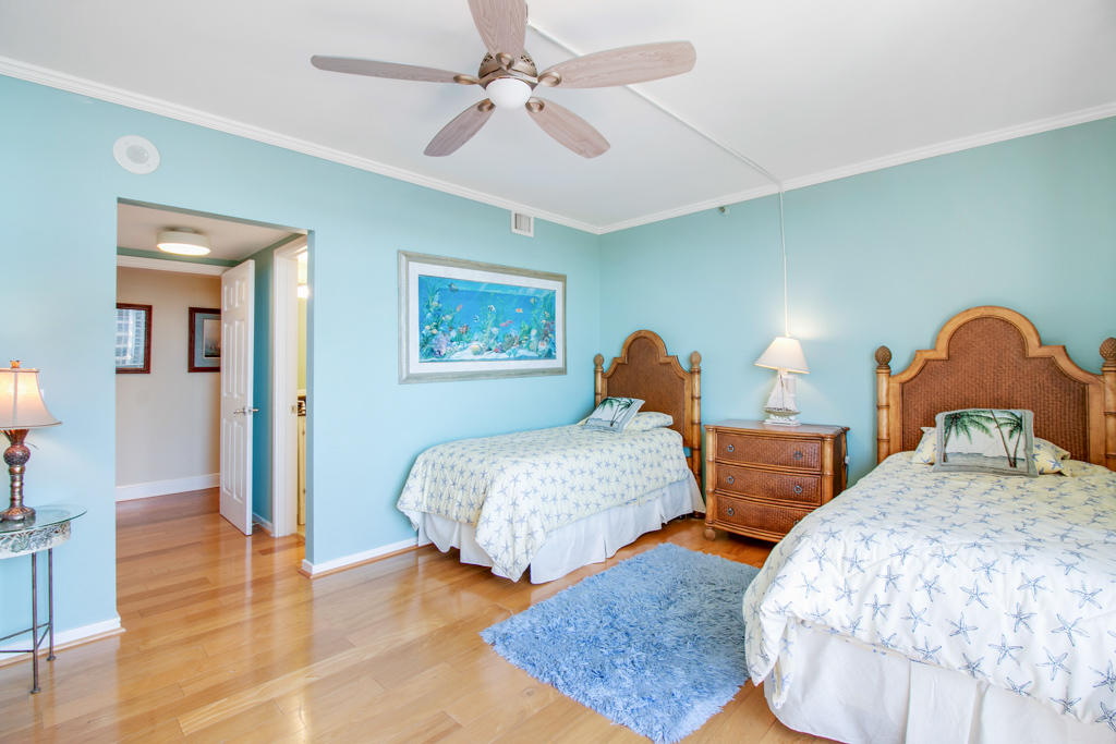 4100 North Ocean Drive, Unit 1002 Singer Island, FL 33404 - Photo 26 of 37 a bedroom with two beds and painting on the wall