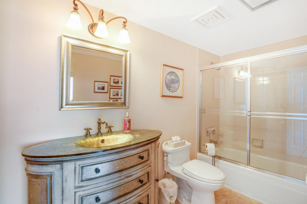 4100 North Ocean Drive, Unit 1002 Singer Island, FL 33404 - Photo 30 of 37 a bathroom with a sink a toilet and shower