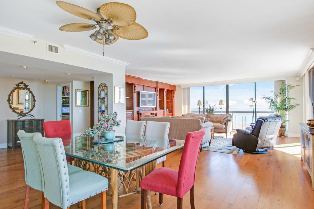 4100 North Ocean Drive, Unit 1002 Singer Island, FL 33404 - Photo 7 of 37 a view of a dining room with furniture wooden floor and chandelier