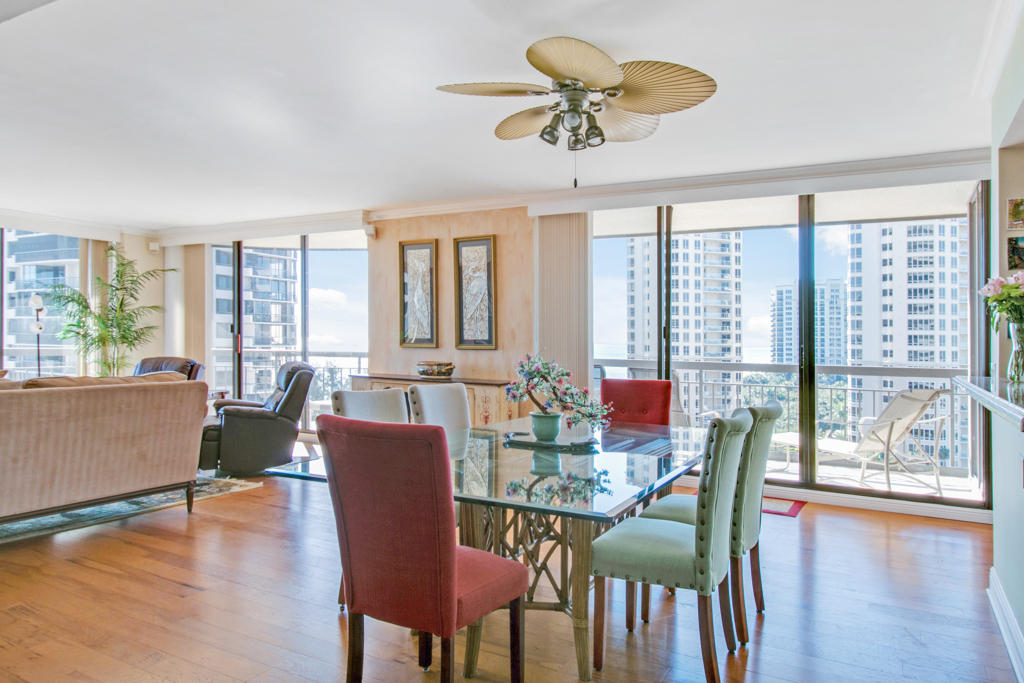 4100 North Ocean Drive, Unit 1002 Singer Island, FL 33404 - Photo 8 of 37 a view of a dining room with furniture window and wooden floor