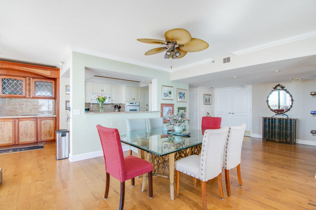4100 North Ocean Drive, Unit 1002 Singer Island, FL 33404 - Photo 9 of 37 a view of a dining room with furniture and wooden floor