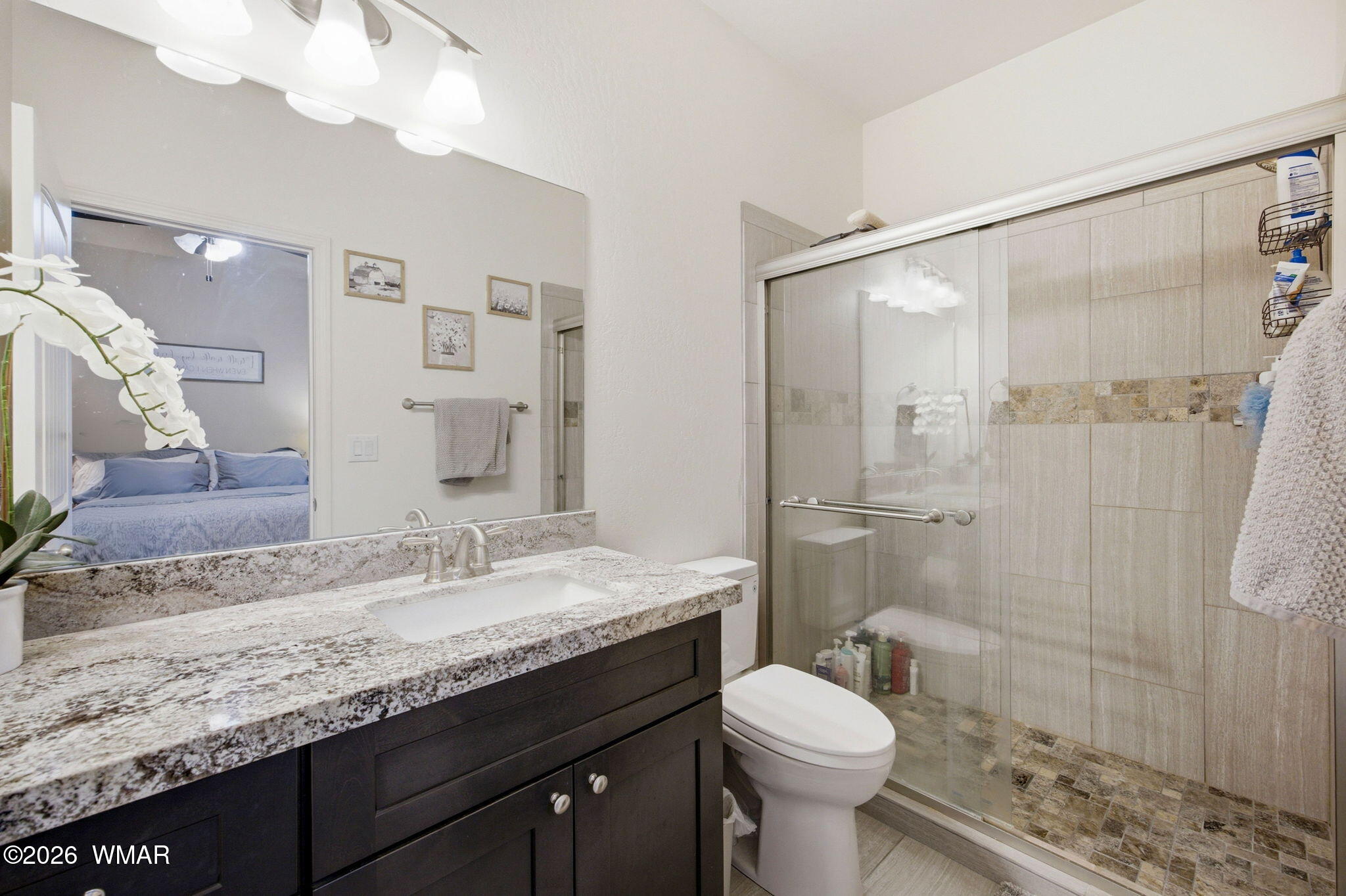 588 Rim Road Pinedale, AZ 85934 - Photo 17 of 30 a bathroom with a granite countertop sink toilet and shower