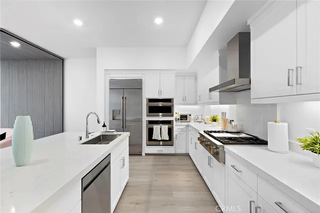 a kitchen with stainless steel appliances a stove sink microwave and cabinets