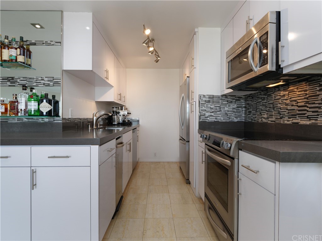 531 Esplanade, Unit 913 Redondo Beach, CA 90277 - Photo 17 of 42 a kitchen with stainless steel appliances granite countertop a stove and a sink