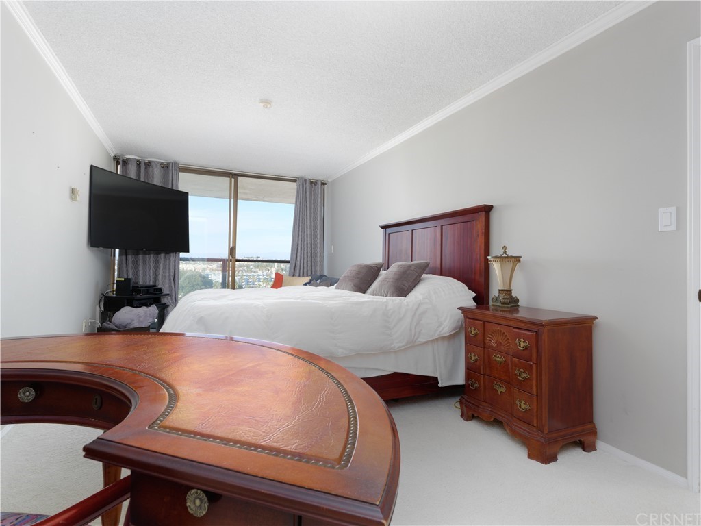 531 Esplanade, Unit 913 Redondo Beach, CA 90277 - Photo 28 of 42 a bedroom with a bed and flat screen tv