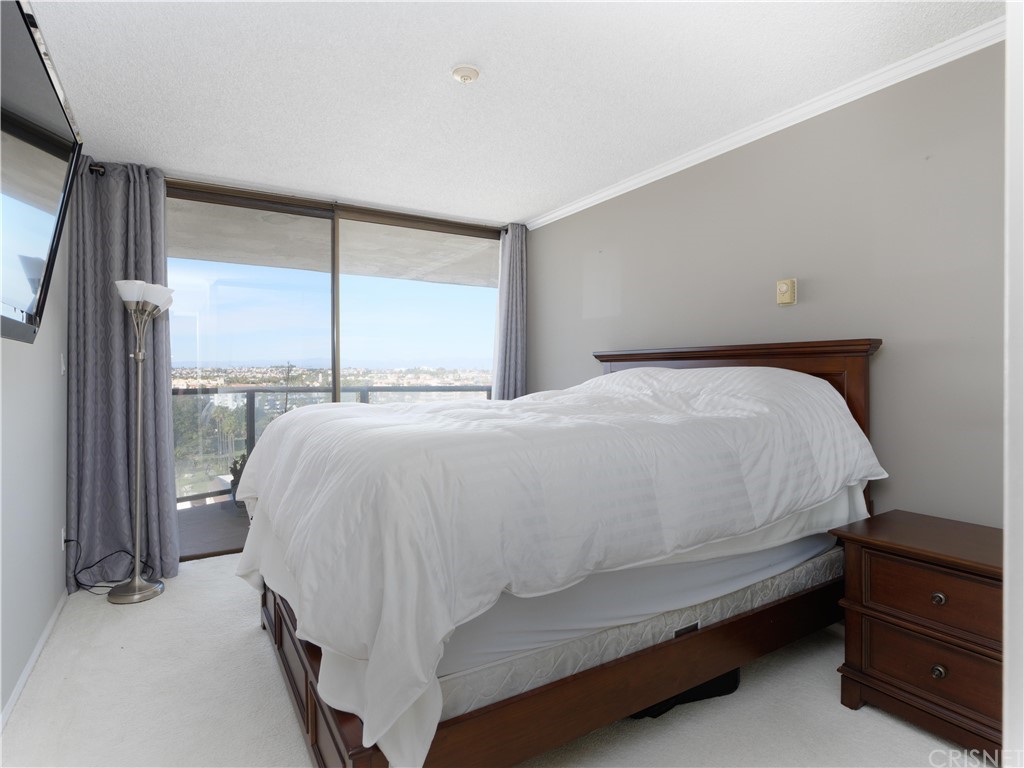 531 Esplanade, Unit 913 Redondo Beach, CA 90277 - Photo 34 of 42 a large bed sitting in a bedroom next to a window