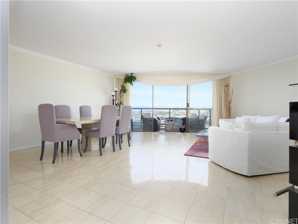 531 Esplanade, Unit 913 Redondo Beach, CA 90277 - Photo 9 of 42 a living room with furniture and a dining table with kitchen view