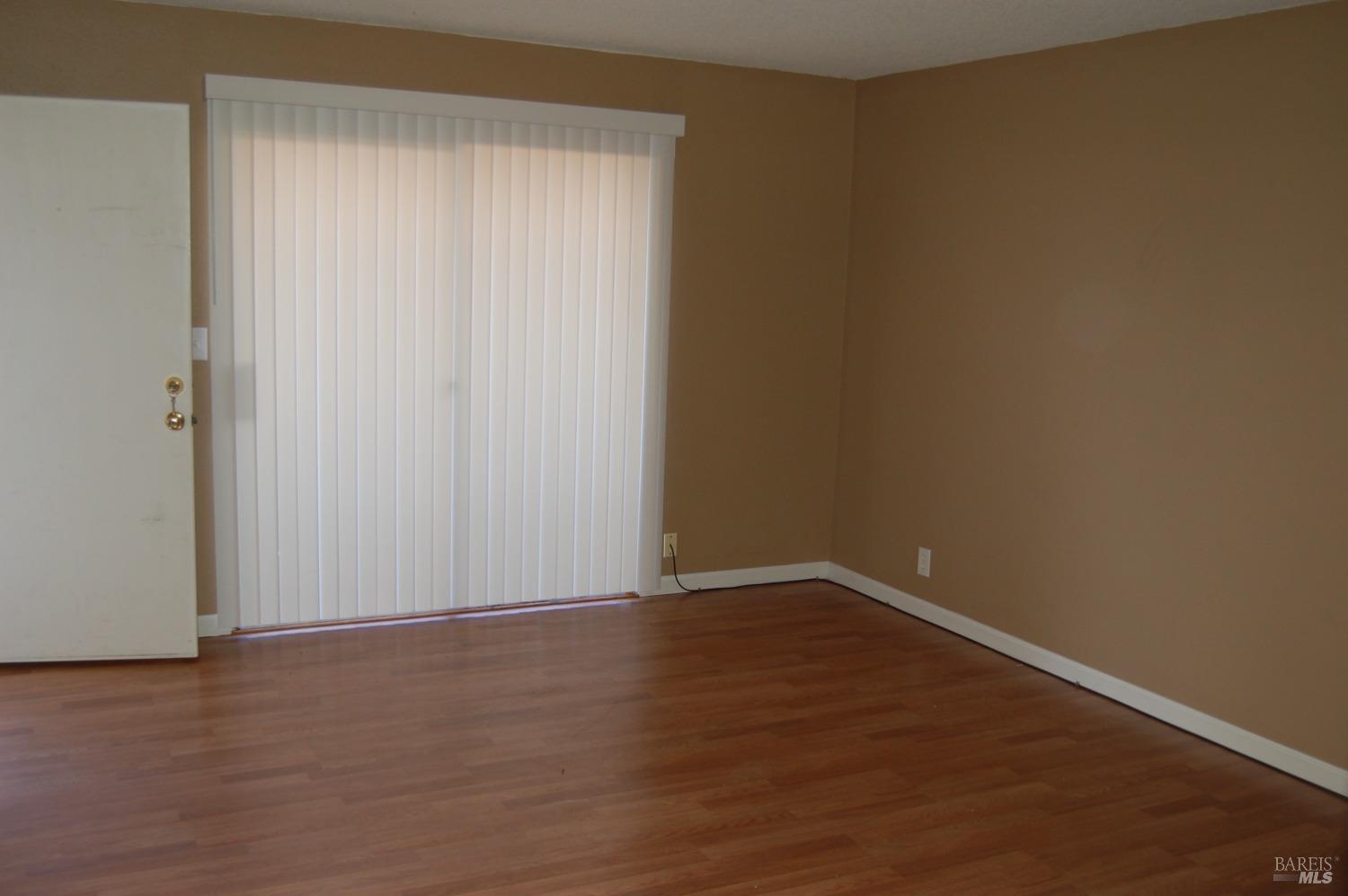 27 South 3rd Street, Unit 6 Rio Vista, CA 94571 - Photo 3 of 5 a view of an empty room with wooden floor