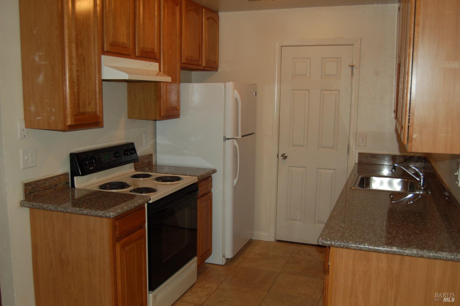 27 South 3rd Street, Unit 6 Rio Vista, CA 94571 - Photo 4 of 5 a kitchen with a sink and a stove