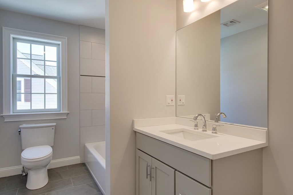 1 Colgate Road Needham, MA 02492 - Photo 16 of 30 a bathroom with a toilet sink and mirror