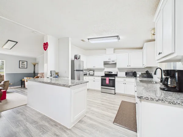 a kitchen with counter top space and sink