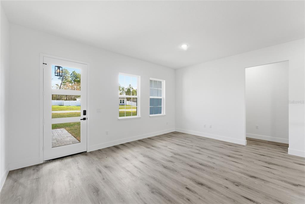 2600 Southwest 146th Pl Road Ocala, FL 34473 - Photo 36 of 40 an empty room with wooden floor and window