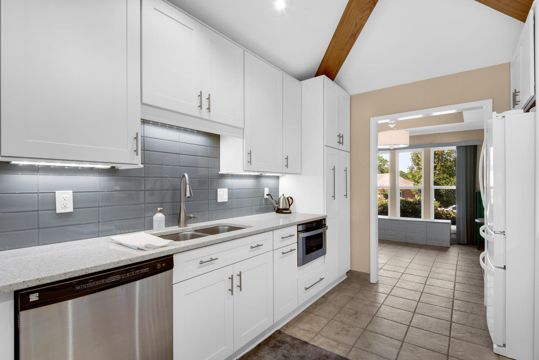 310 Antiqua Way Niceville, FL 32578 - Photo 13 of 39 a kitchen with a sink and cabinets