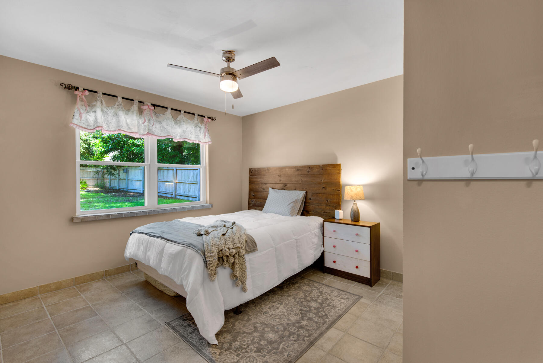 310 Antiqua Way Niceville, FL 32578 - Photo 30 of 39 a bed sitting in a bedroom next to a window