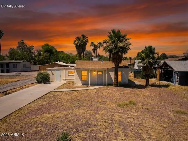 a view of a house with palm trees