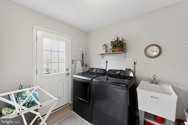 a view of a patio with table and chairs with wooden floor and fence