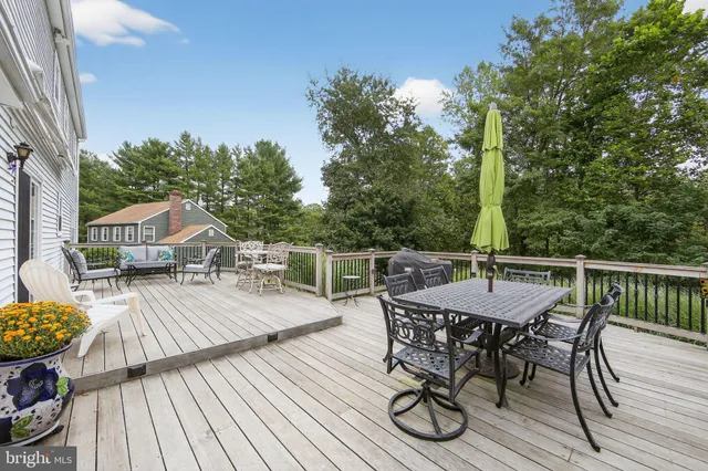 a view of backyard with a deck and furniture