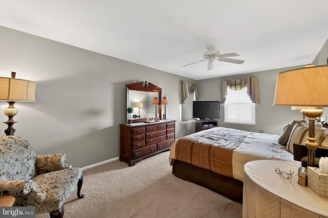 a bedroom with a bed and a lamp