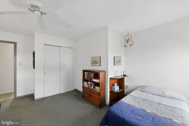 a bedroom with a bed and a table in it