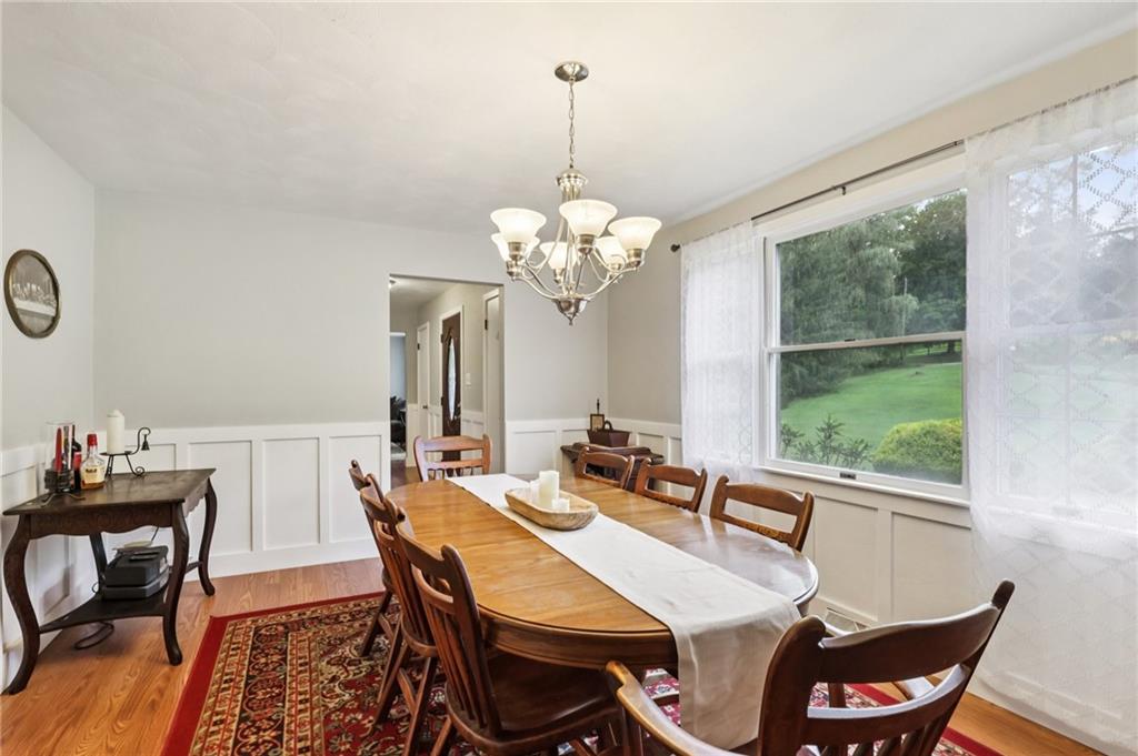 748 Four Mile Run Road Ligonier, PA 15658 - Photo 20 of 49 a dining room with furniture a large window and a chandelier