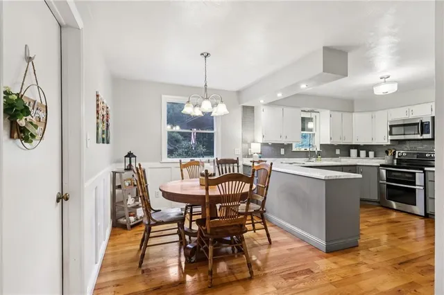 a view of a dining room with furniture window and wooden floor
