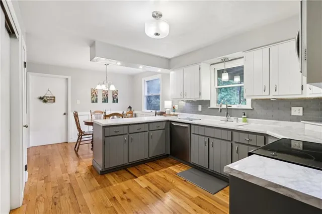 a kitchen with a sink appliances and cabinets