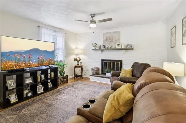 a living room with furniture a fireplace and a flat screen tv