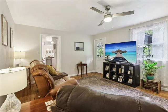 a living room with furniture a chandelier and a window