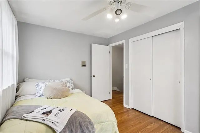 a bedroom with a bed and wooden floor