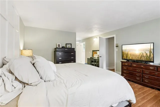 a bedroom with a bed and a flat screen tv