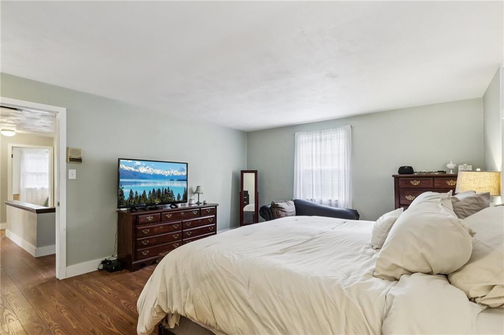 748 Four Mile Run Road Ligonier, PA 15658 - Photo 41 of 49 a bedroom with a bed and wooden floor